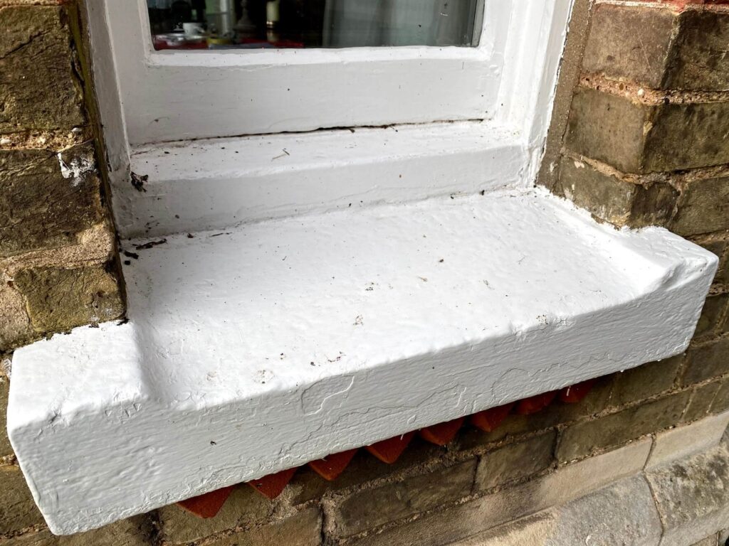 Unsightly paintwork on masonry sills and features
