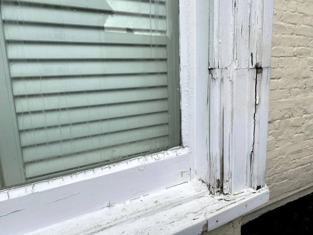 Peeling paint and rotten wood on sash windows