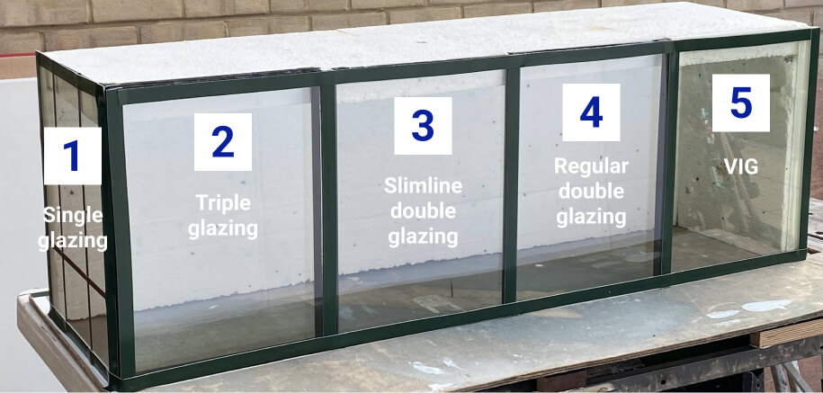 Five sections of a window display showcase various glazing types: single, triple, and the ideal slimline double glazing for listed buildings, along with regular double and VIG (Vacuum Insulated Glass).