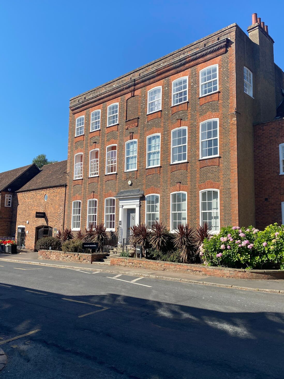 A red brick building on the corner of a street in Hertfordshire.